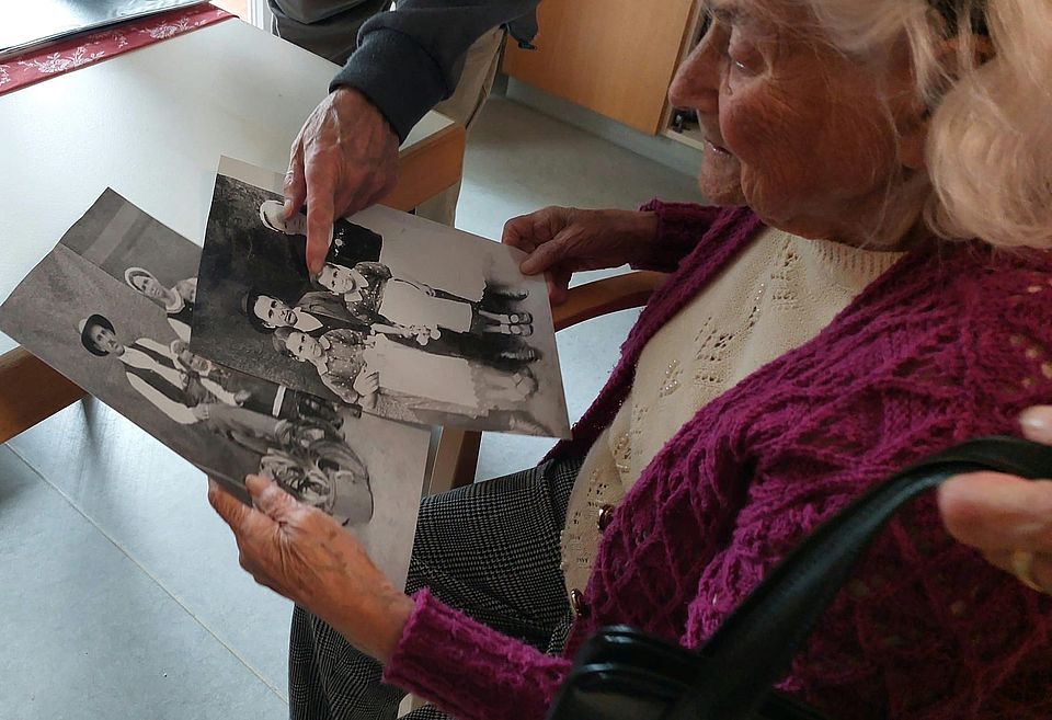 Geschwister schauen alte Familienfotos an